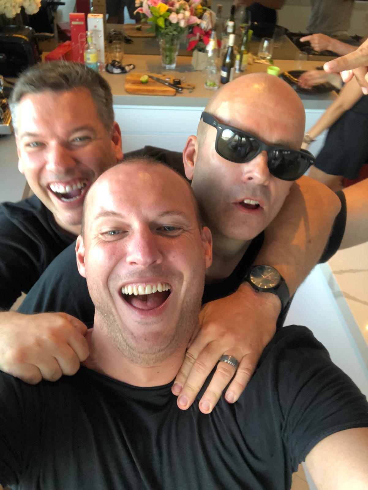 Three blokes in the kitchen, having a laugh
