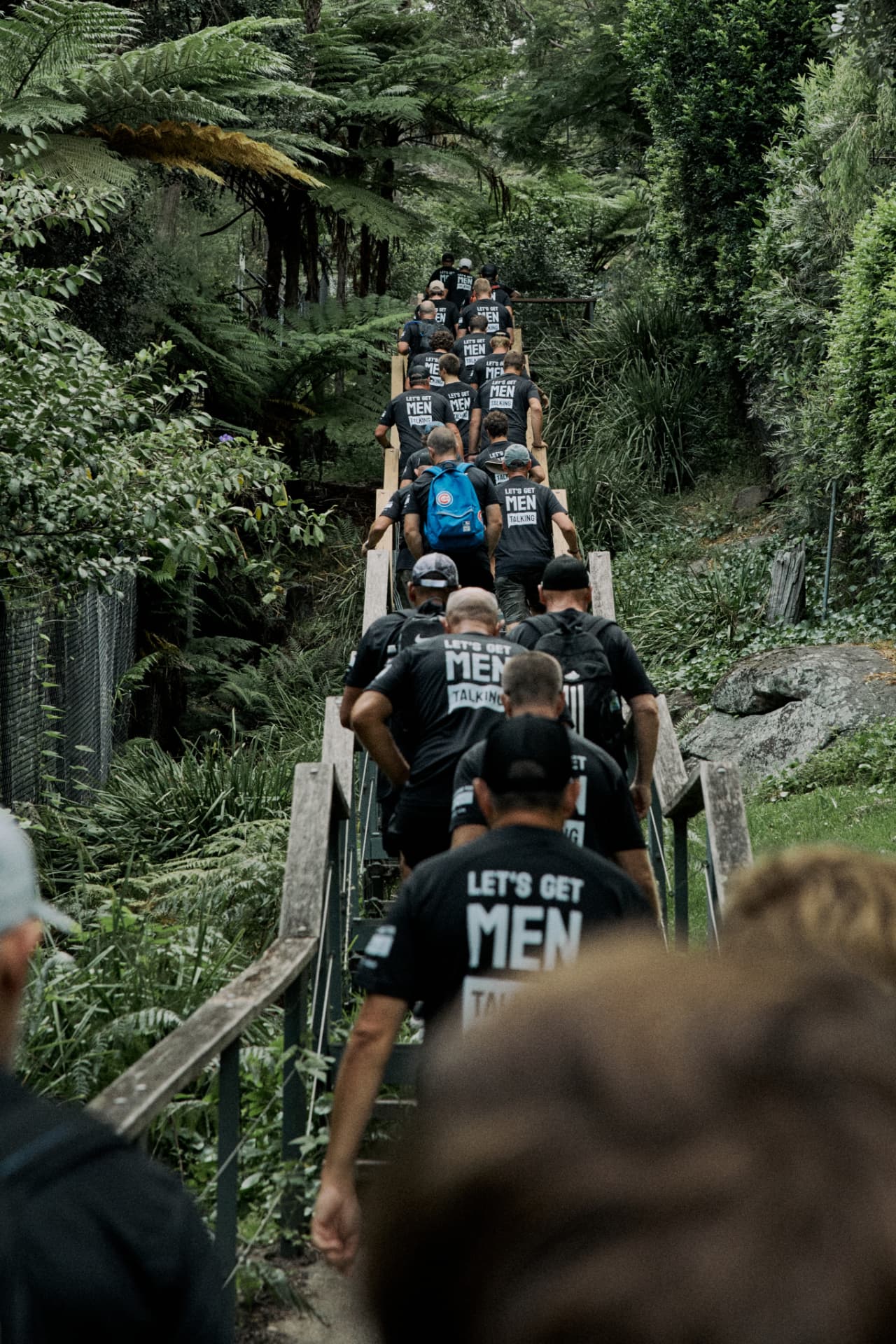 Blokes walking a bush trail in Let's Get Men Talking tees